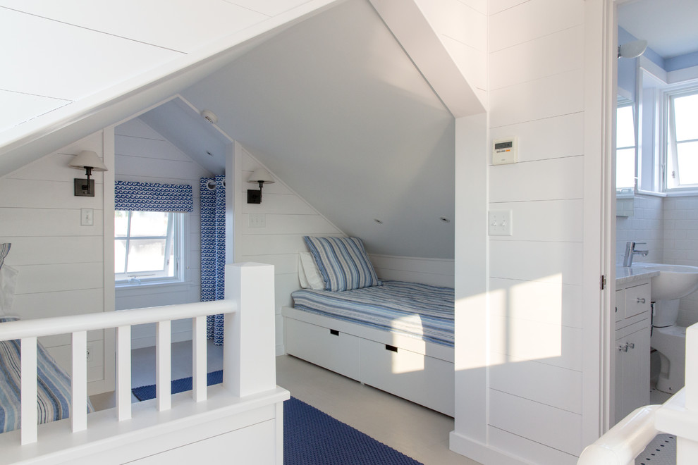 Small beach style loft-style bedroom in Portland Maine with white walls and painted wood floors.