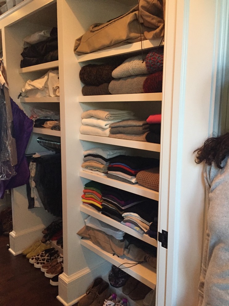 Walk-in closet - mid-sized modern gender-neutral walk-in closet idea in New York