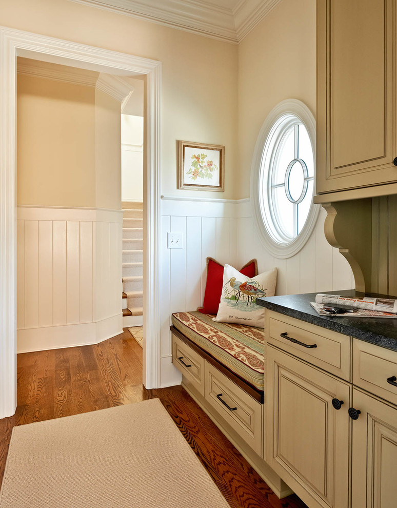 Design ideas for a traditional mudroom in Charlotte with beige walls.