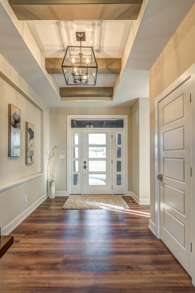 Design ideas for a mid-sized contemporary entry hall in Cincinnati with beige walls, dark hardwood floors, a single front door and a glass front door.