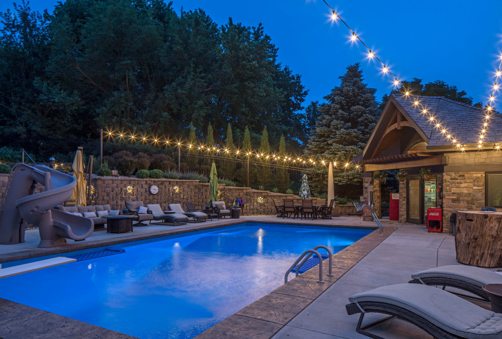 Photo of a country backyard rectangular lap pool in Omaha with a water slide.