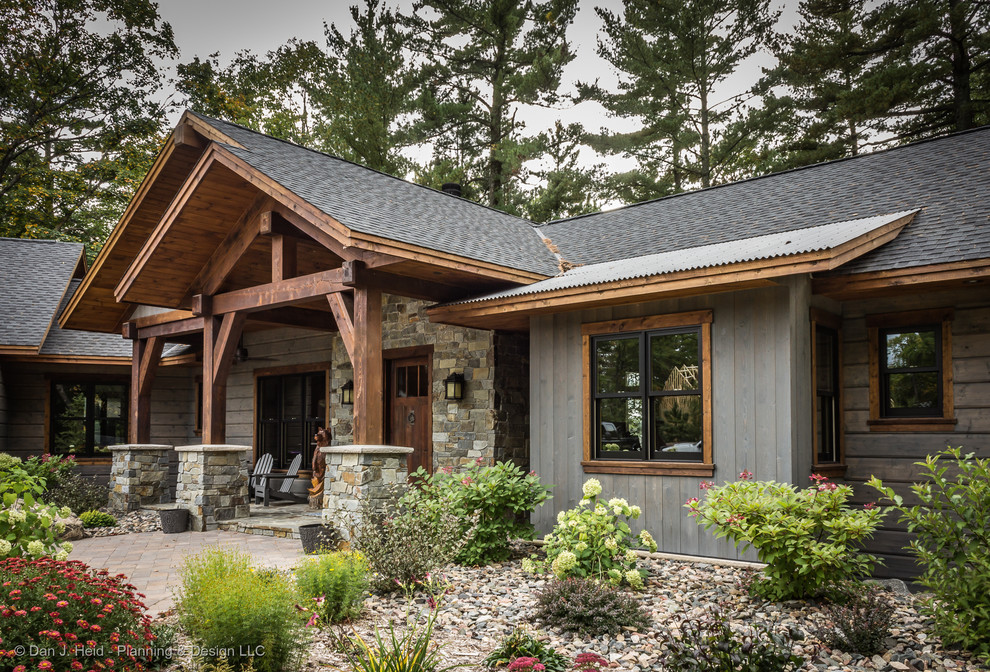 Inspiration for a mid-sized country two-storey grey house exterior in Minneapolis with wood siding, a gable roof and a mixed roof.