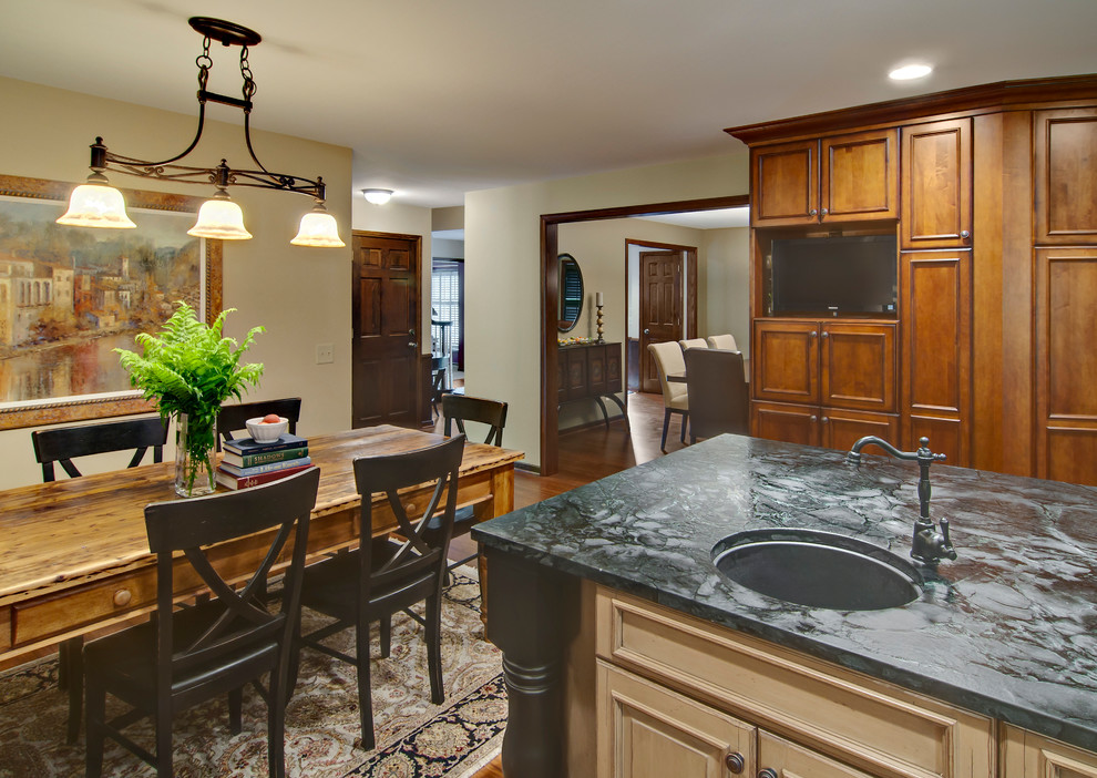 Large transitional u-shaped eat-in kitchen in Minneapolis with an undermount sink, flat-panel cabinets, medium wood cabinets, soapstone benchtops, bamboo floors and with island.