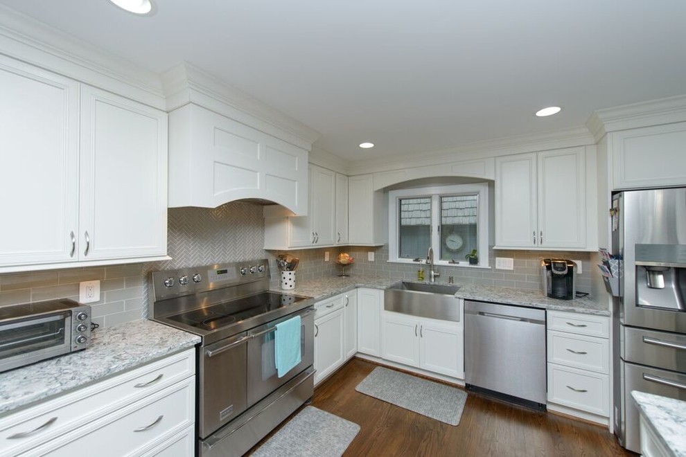 Eat-in kitchen - transitional l-shaped medium tone wood floor eat-in kitchen idea in Baltimore with a farmhouse sink, beaded inset cabinets, white cabinets, granite countertops, gray backsplash, glass tile backsplash, stainless steel appliances and an island