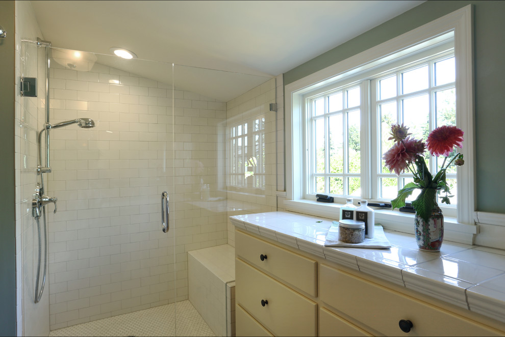 Mid-sized traditional master bathroom in Portland with a pedestal sink, flat-panel cabinets, beige cabinets, tile benchtops, an open shower, a two-piece toilet, white tile, ceramic tile, green walls and ceramic floors.