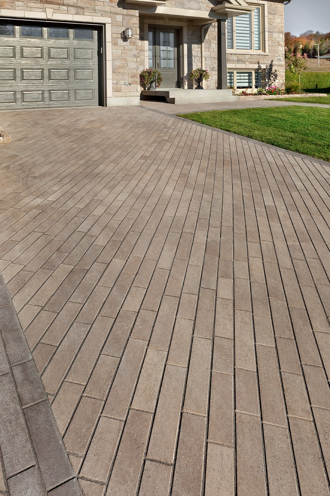 This is an example of a mid-sized transitional front yard driveway.