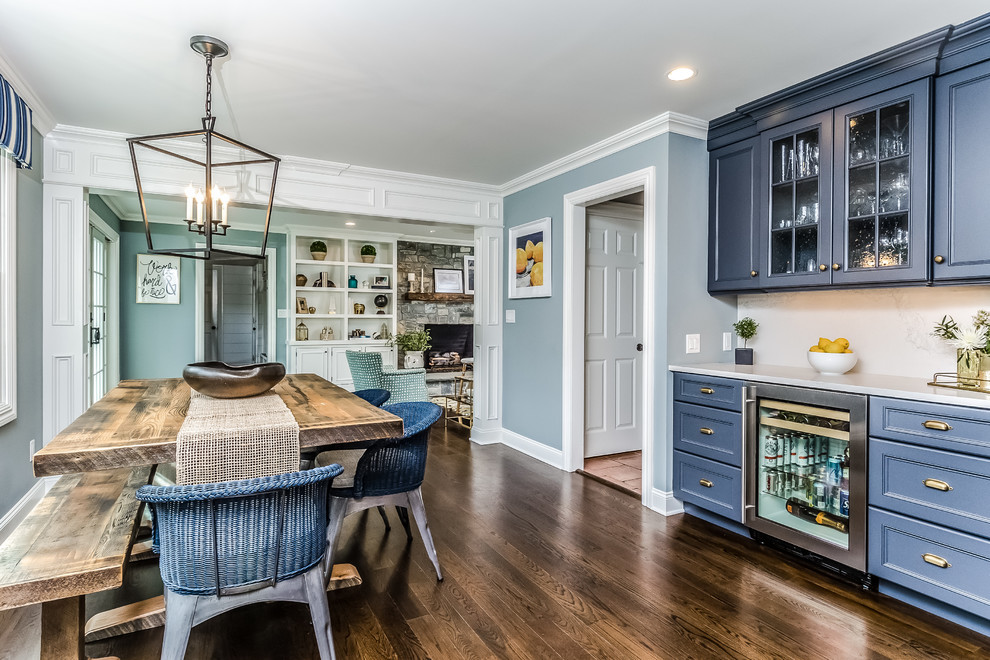 This is an example of a mid-sized transitional separate dining room in New York with blue walls, medium hardwood floors, no fireplace and brown floor.