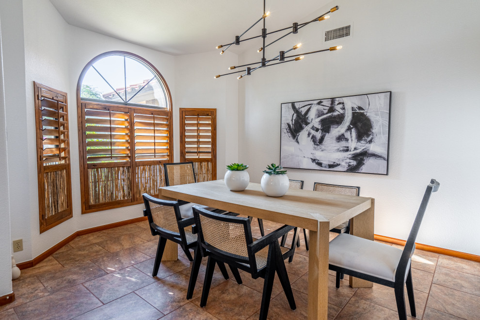 Example of a mid-sized transitional dark wood floor and brown floor breakfast nook design in Phoenix with white walls