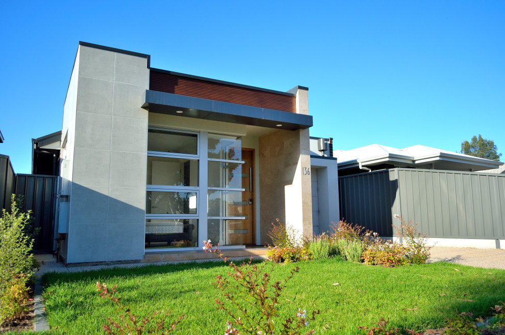 Photo of a small contemporary one-storey multi-coloured house exterior in Adelaide with a metal roof.