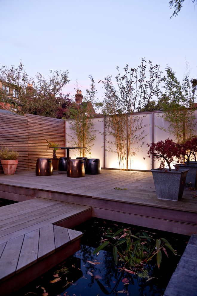 Design ideas for a large modern backyard full sun garden in Los Angeles with with pond and decking.