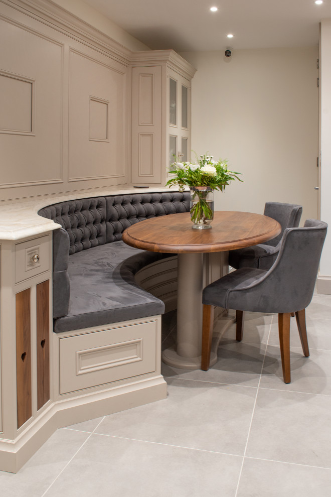 Photo of a mid-sized transitional dining room in West Midlands with beige walls and grey floor.