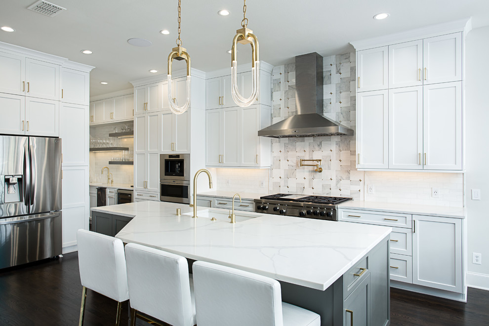 Inspiration for an expansive transitional galley open plan kitchen in Dallas with an undermount sink, shaker cabinets, white cabinets, quartz benchtops, white splashback, marble splashback, stainless steel appliances, dark hardwood floors, with island and brown floor.