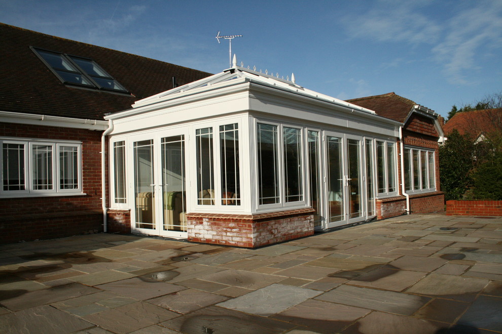 Photo of an expansive traditional sunroom in Sussex with a skylight.
