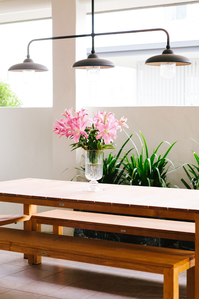 This is an example of a transitional patio in Brisbane with a roof extension.