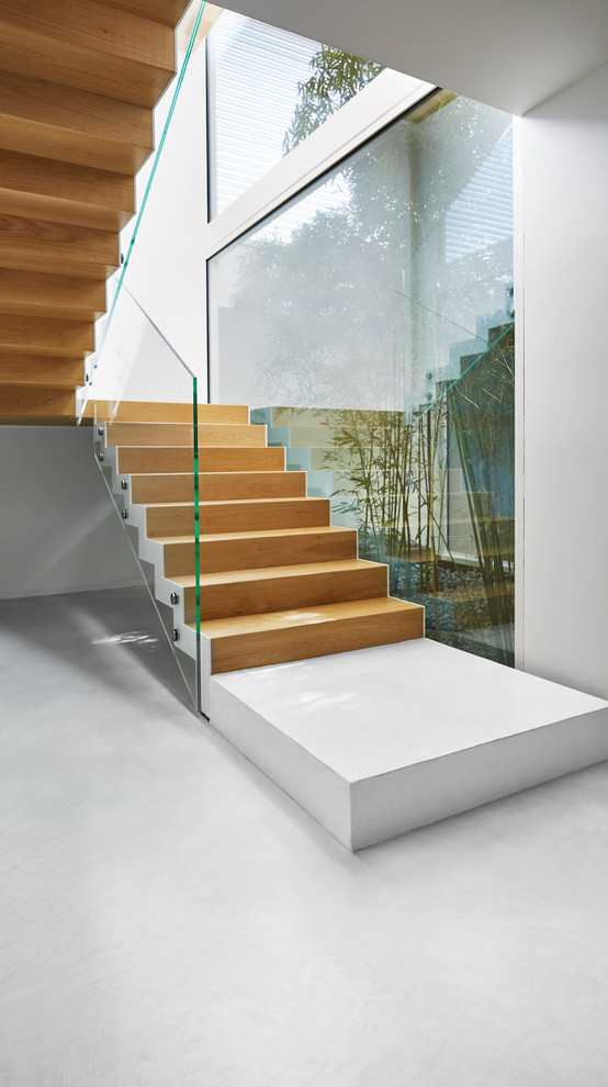 Inspiration for a contemporary wood u-shaped staircase in Venice with wood risers.