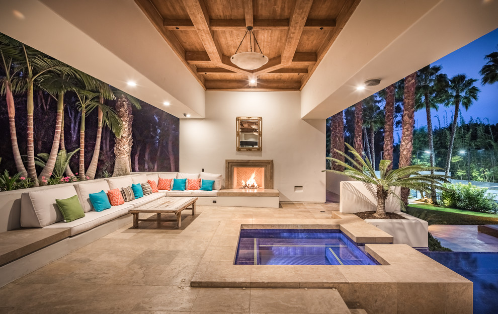 Expansive contemporary backyard patio in San Diego with a roof extension, tile and with fireplace.