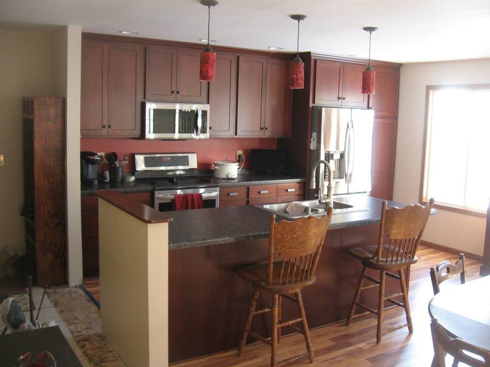 Eat-in kitchen - eat-in kitchen idea with dark wood cabinets and quartz countertops