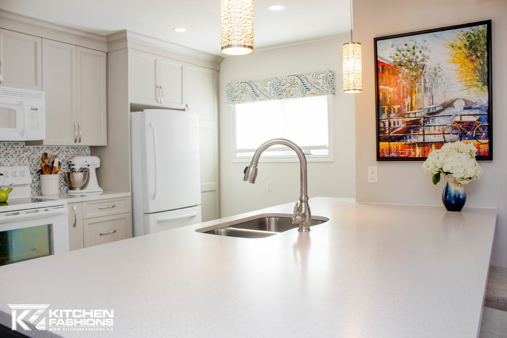 Inspiration for a mid-sized transitional single-wall ceramic tile open concept kitchen remodel with an undermount sink, shaker cabinets, gray cabinets, solid surface countertops, gray backsplash, mosaic tile backsplash, white appliances and an island