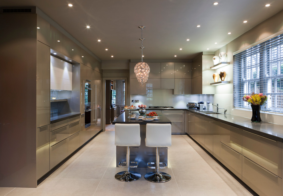 Inspiration for a large contemporary u-shaped eat-in kitchen in London with an undermount sink, flat-panel cabinets, white splashback, stainless steel appliances, ceramic floors and with island.