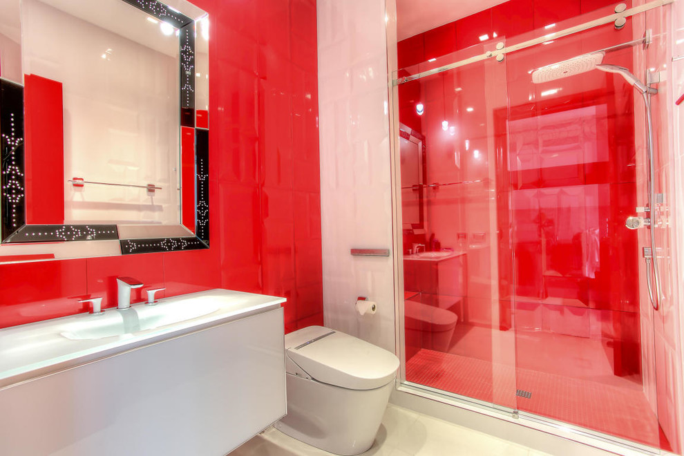 Photo of a small contemporary 3/4 bathroom in Miami with flat-panel cabinets, white cabinets, an alcove shower, a bidet, red tile, porcelain tile, red walls, porcelain floors, an integrated sink and glass benchtops.