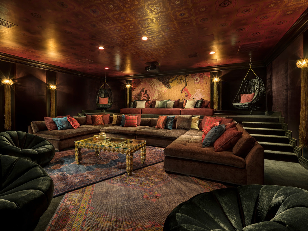 This is an example of a large asian enclosed home theatre in Phoenix with red walls, carpet, a projector screen and grey floor.