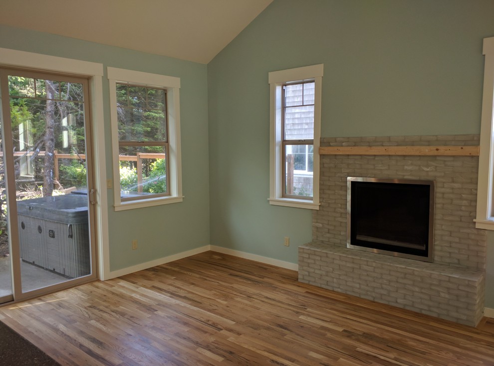 Photo of a small arts and crafts open concept living room in Portland with blue walls, a tile fireplace surround, no tv, medium hardwood floors and a standard fireplace.