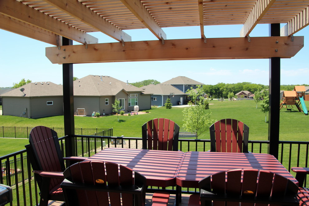 Large backyard deck photo with a pergola