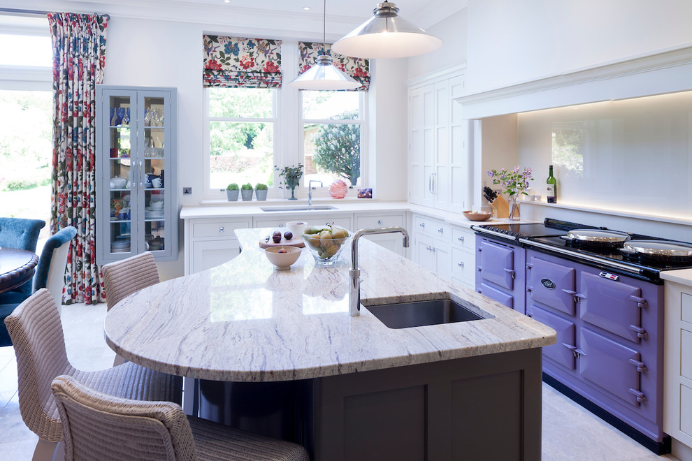 Photo of a mid-sized transitional galley eat-in kitchen in Cheshire with an undermount sink, shaker cabinets, white cabinets, coloured appliances, with island, beige floor and beige benchtop.