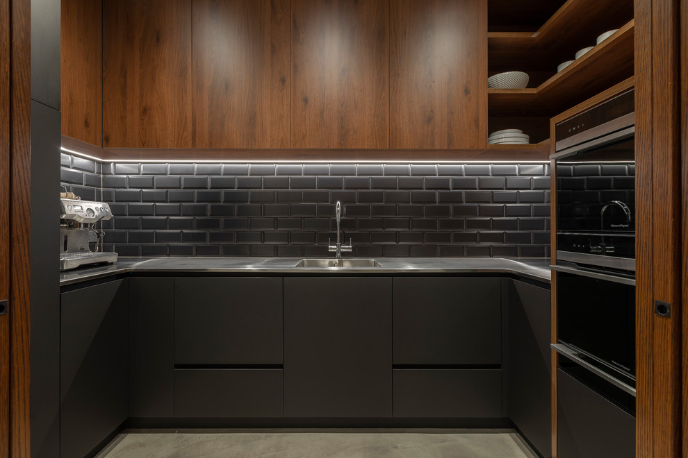 Photo of a large contemporary galley eat-in kitchen in Auckland with grey cabinets, tile benchtops, metallic splashback, metal splashback, with island and black benchtop.