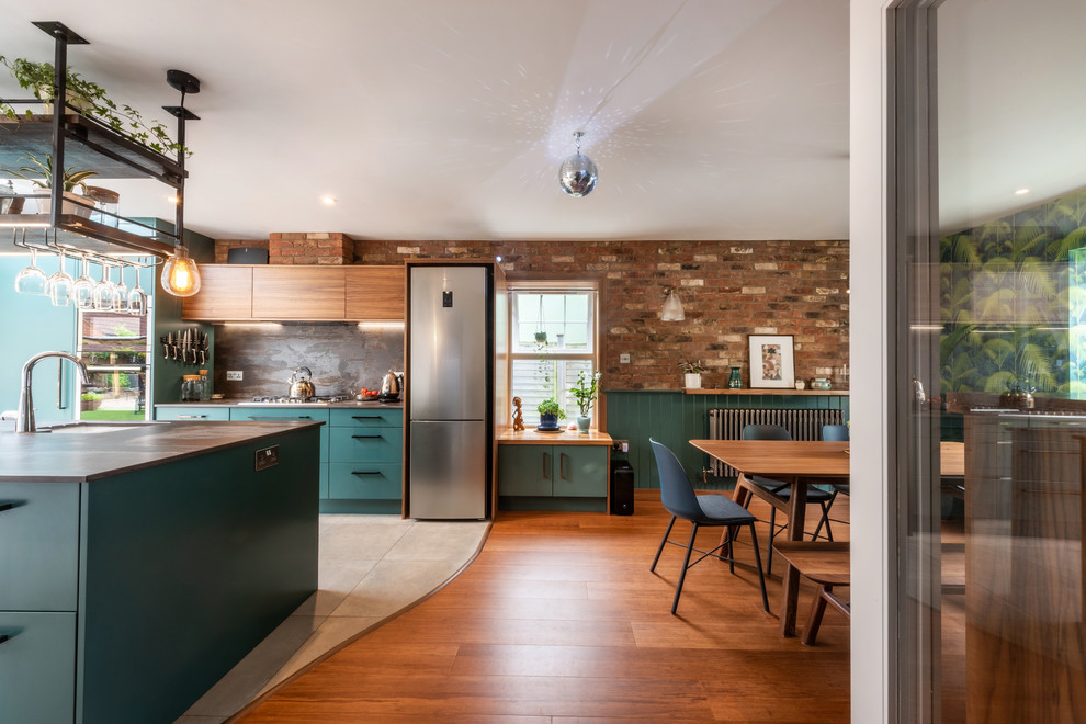 Inspiration for a mid-sized contemporary galley eat-in kitchen in Other with a drop-in sink, turquoise cabinets, quartzite benchtops, metallic splashback, slate splashback, stainless steel appliances, porcelain floors, white floor and multi-coloured benchtop.