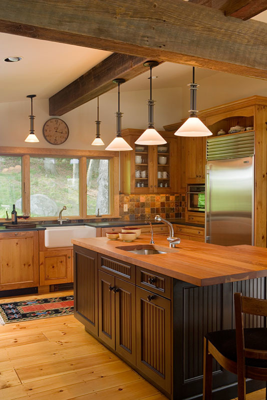 Large mountain style u-shaped medium tone wood floor eat-in kitchen photo in Jacksonville with a farmhouse sink, recessed-panel cabinets, medium tone wood cabinets, wood countertops, multicolored backsplash, slate backsplash, stainless steel appliances and an island