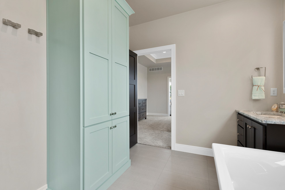 Example of a large transitional master ceramic tile, gray floor and double-sink bathroom design with shaker cabinets, medium tone wood cabinets, a two-piece toilet, gray walls, an undermount sink, marble countertops, green countertops and a built-in vanity