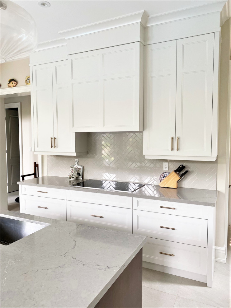 Inspiration for a mid-sized transitional porcelain tile open concept kitchen remodel in Toronto with an undermount sink, recessed-panel cabinets, white cabinets, quartz countertops, gray backsplash, porcelain backsplash, stainless steel appliances, an island and gray countertops