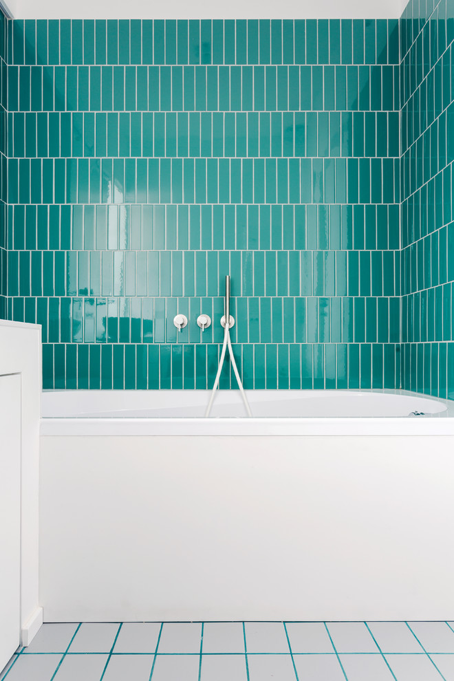 Inspiration for a small contemporary kids bathroom in Milan with flat-panel cabinets, white cabinets, an alcove tub, blue tile, green tile, porcelain tile, white walls, porcelain floors, solid surface benchtops, white floor, white benchtops, a shower/bathtub combo and an open shower.