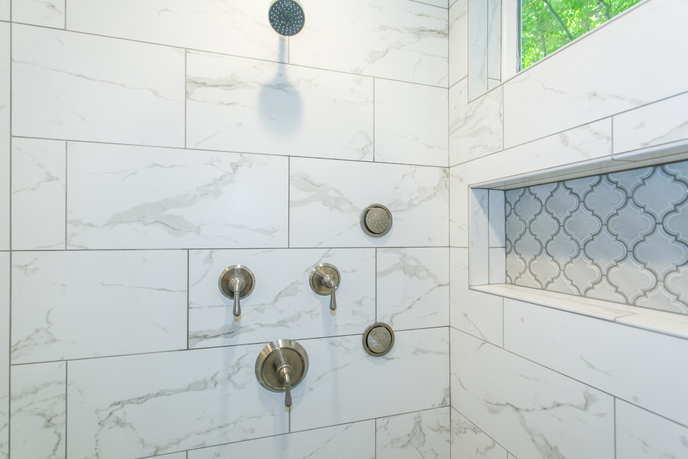 Photo of a mid-sized traditional master bathroom in Portland with raised-panel cabinets, white cabinets, a freestanding tub, white tile, marble, grey walls, ceramic floors, an undermount sink, engineered quartz benchtops, grey floor, a hinged shower door and white benchtops.