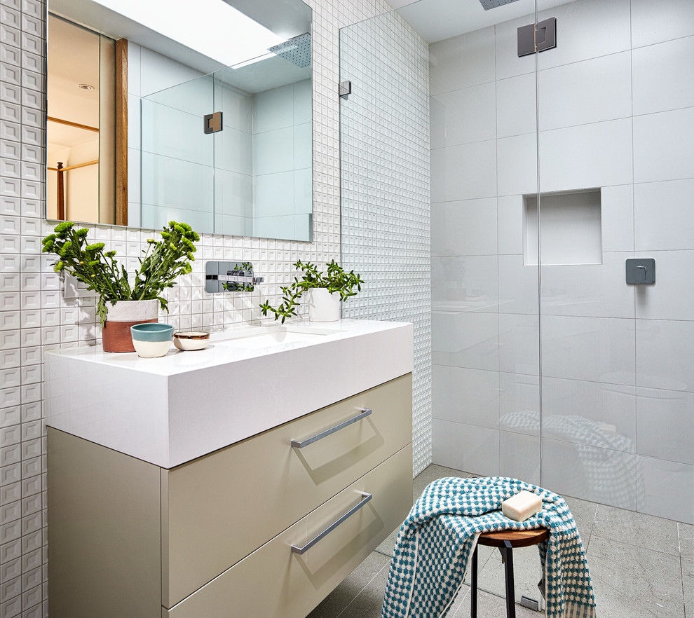Design ideas for a small contemporary bathroom in Melbourne with beige cabinets, porcelain tile, white walls and solid surface benchtops.