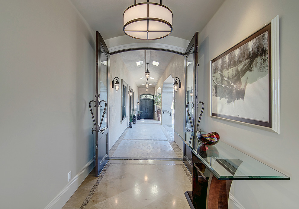 Inspiration for a transitional travertine floor and beige floor entryway remodel in Orange County with white walls