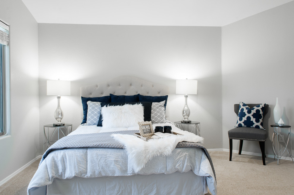Design ideas for a mid-sized transitional master bedroom in Phoenix with grey walls and carpet.