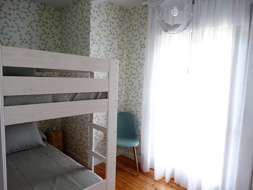 This is an example of a small transitional gender-neutral kids' bedroom in Other with light hardwood floors.