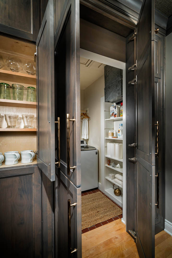 Kitchen - transitional light wood floor kitchen idea with a farmhouse sink, gray cabinets, quartz countertops, white backsplash, subway tile backsplash and stainless steel appliances