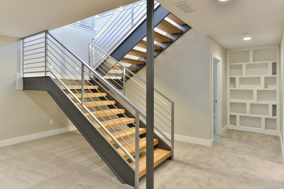 Photo of a mid-sized contemporary wood l-shaped staircase in Denver with open risers and metal railing.