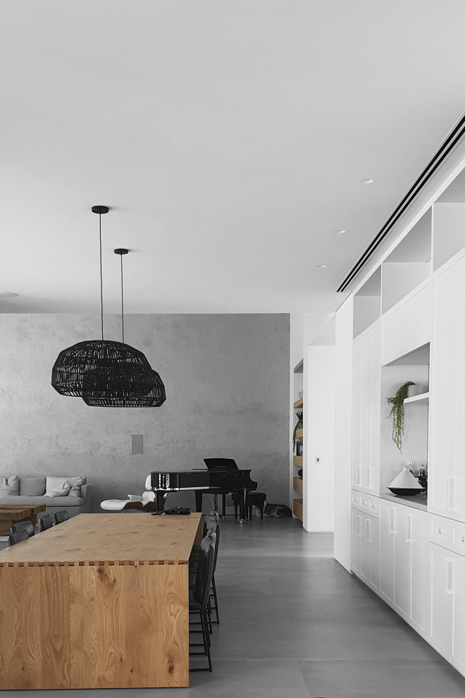 This is an example of a large modern kitchen/dining combo in Tel Aviv with grey walls, ceramic floors, no fireplace and grey floor.