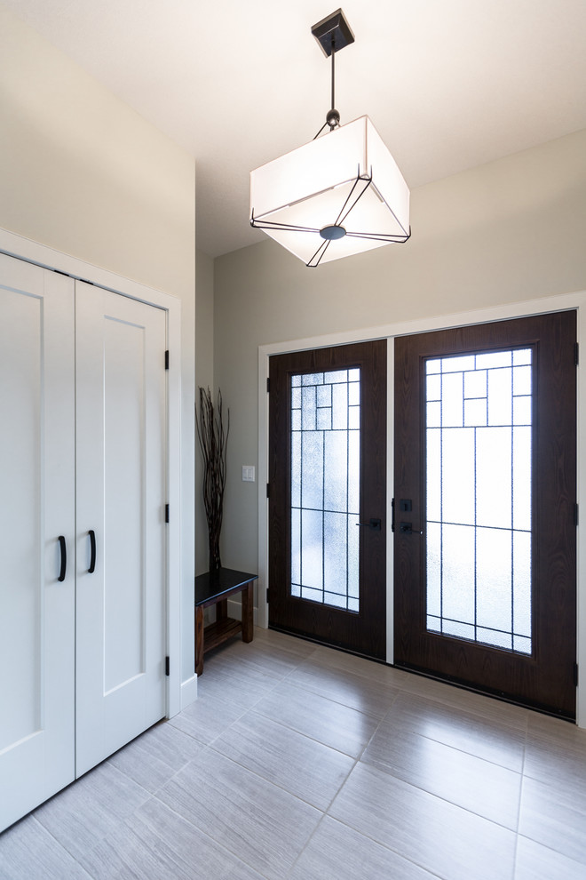 Inspiration for a small transitional porcelain tile front door remodel with gray walls and a dark wood front door