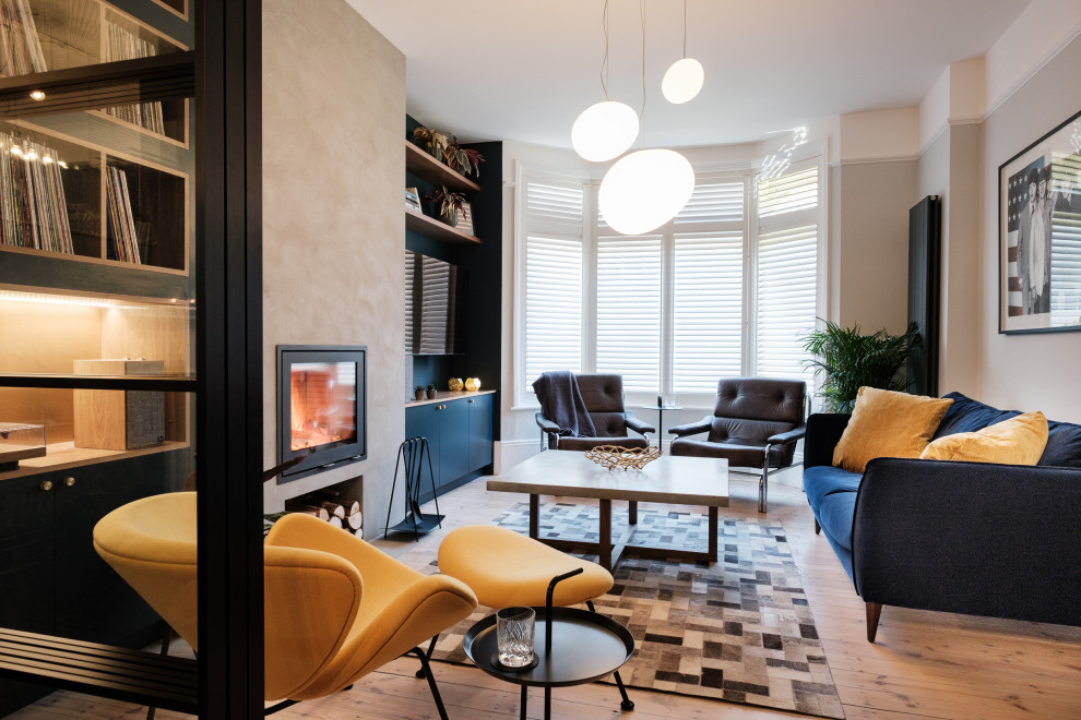 This is an example of a modern living room in London with a wood burning stove and a concrete fireplace surround.