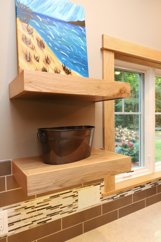 Mid-sized transitional u-shaped light wood floor and brown floor eat-in kitchen photo in Grand Rapids with an undermount sink, flat-panel cabinets, light wood cabinets, quartz countertops, brown backsplash, ceramic backsplash, stainless steel appliances and an island