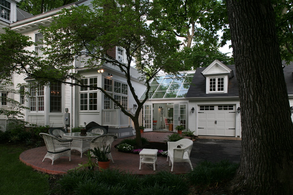 This is an example of a large eclectic two-storey white exterior in St Louis with wood siding, a gable roof and a shingle roof.