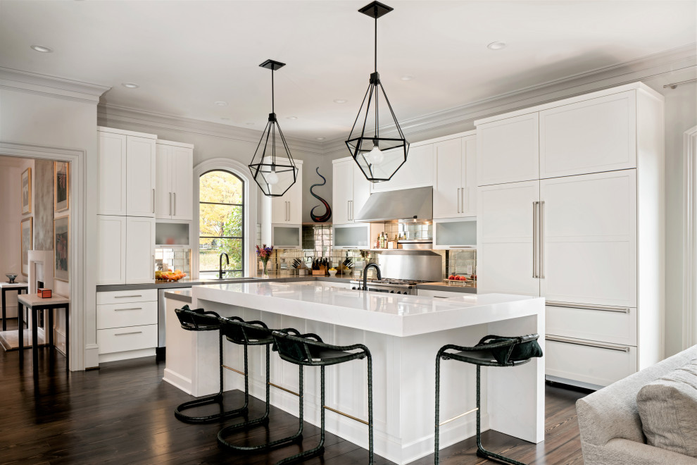Inspiration for a large transitional l-shaped open plan kitchen in Charlotte with shaker cabinets, white cabinets, quartz benchtops, metallic splashback, panelled appliances, dark hardwood floors, with island, brown floor, grey benchtop and metal splashback.