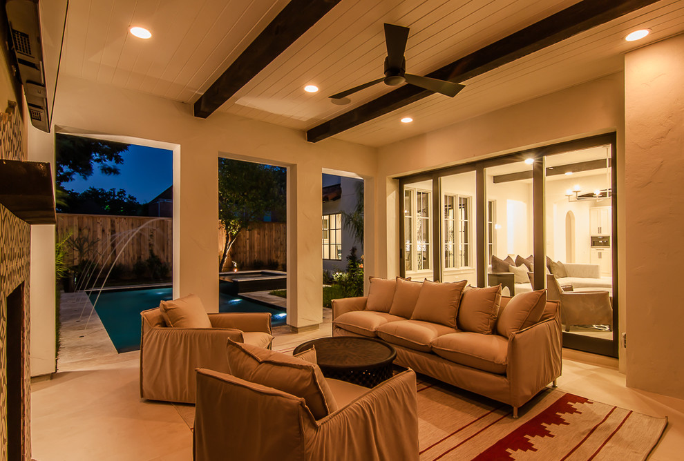 Photo of a mid-sized mediterranean backyard patio in Houston with a fire feature, decking and a roof extension.
