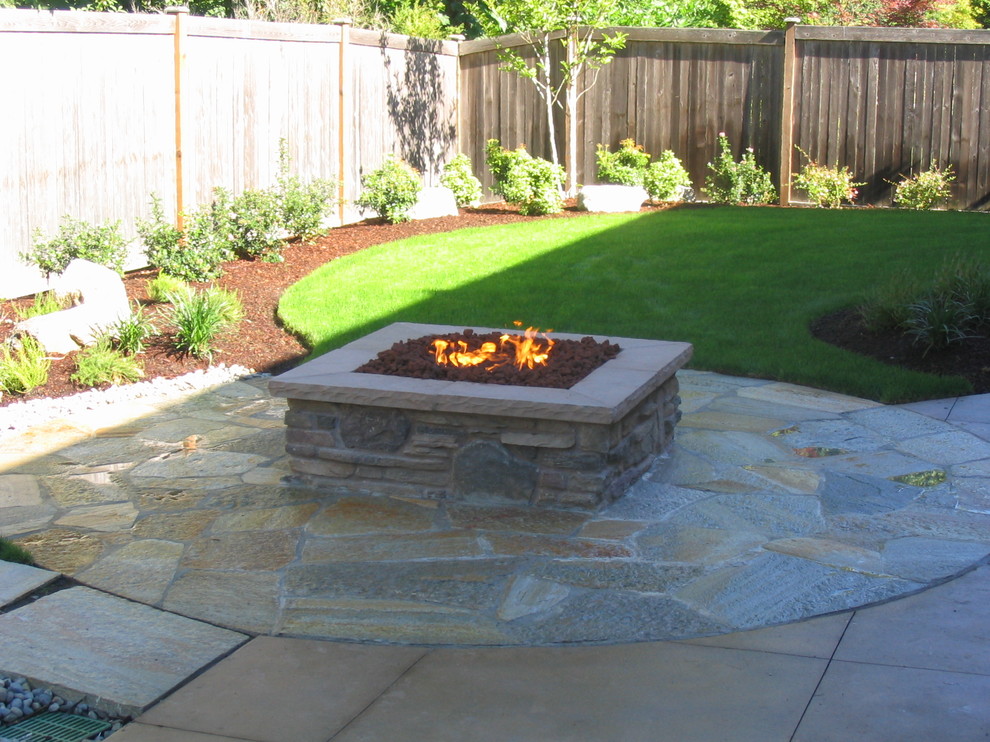 Photo of a traditional patio in Seattle with natural stone pavers.