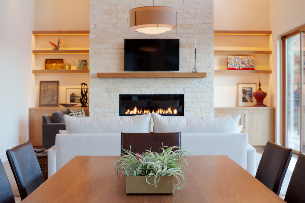 Design ideas for a large contemporary open concept living room in San Francisco with white walls, medium hardwood floors, a ribbon fireplace, a stone fireplace surround and a wall-mounted tv.